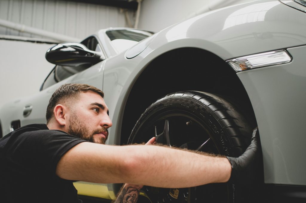 a man do a car detailing in shop